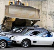 Bulldozer crushes 30 luxury cars
