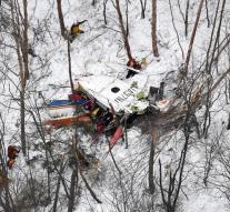 crashed helicopter with rescuers