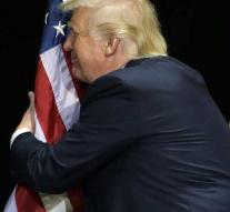 Donald Trump is hugging the American flag
