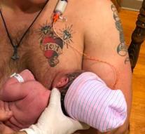 Father breastfeeding little girl