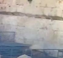 Huge stone falls from Wailing Wall and misses old woman on a hair