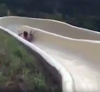 Man flying from wild water slide