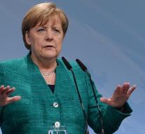 Merkel promises compensation after riots