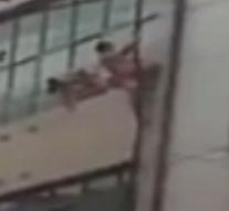 Naked Chinese cheater falls from drainpipe