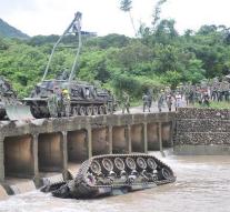Tank falls off bridge: three dead