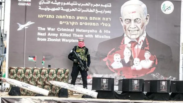 Hamas Hands Over Hostage Corpses in Black Coffins
