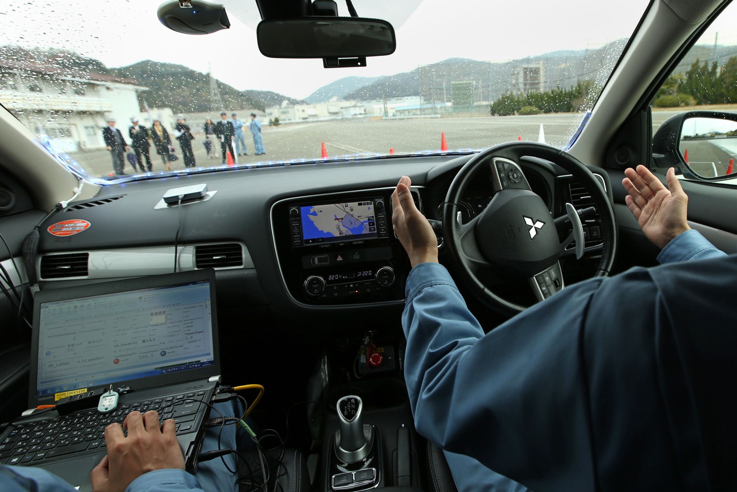 Mitsubishi Driver. Driver without car. Technology Driver. Car way on the Screen on Driving software.